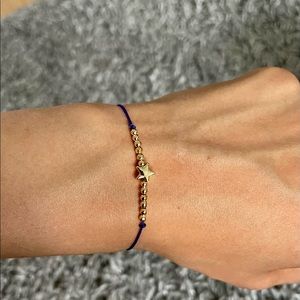 Hand made bracelet purple colour with gold beads